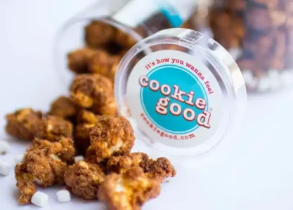 Cookies spilled from a jar labeled 'cookie good' with the slogan 'It's how you wanna feel' visible in the foreground.