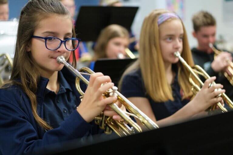 elementary students play instruments