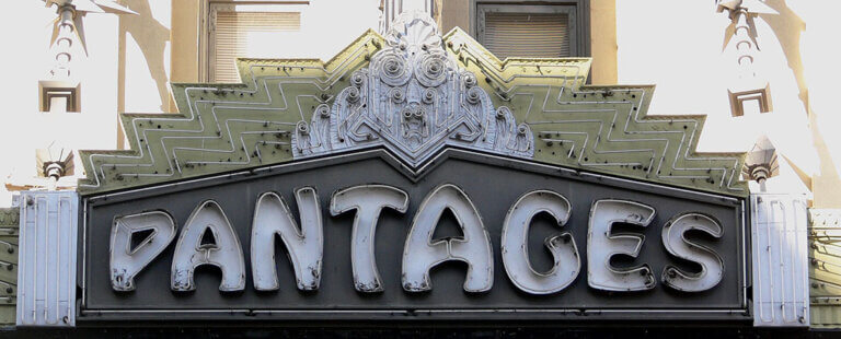 Marquee sign reading 'Pantages' with ornate Art Deco detailing above the entrance.