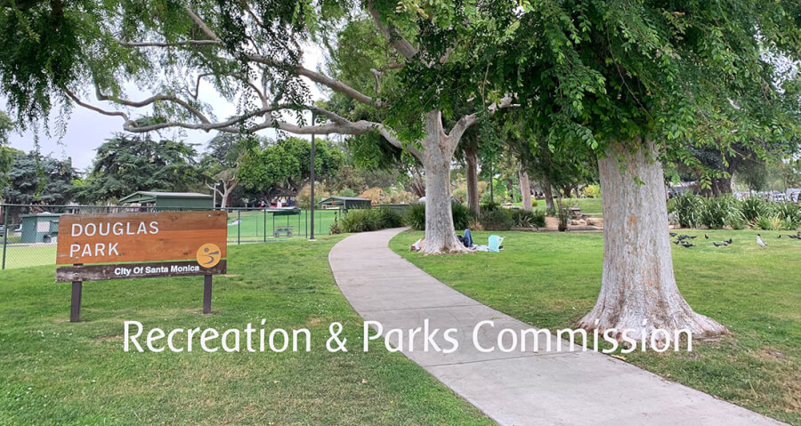 Sign reads 'Douglas Park' and 'City Of Santa Monica' at the edge of a grassy park with a winding concrete path and large trees overhead, conveying a park scene for Recreation & Parks Commission.