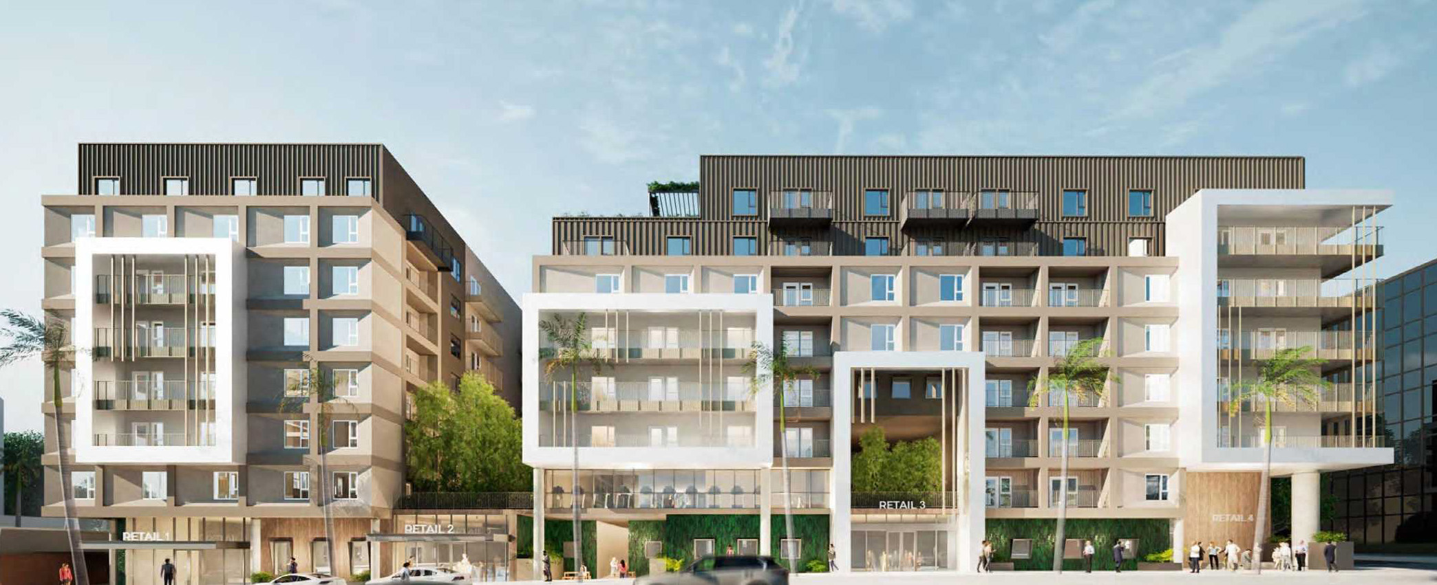 Modern mixed-use building with retail on the ground floor and a glass-framed central atrium in a contemporary complex.