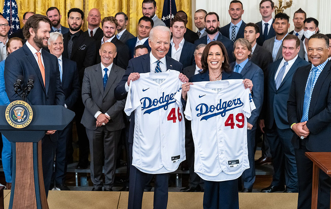 Los Angeles Dodgers jerseys Biden Harris | Santa Monica Sun President and Vice President display Dodgers jerseys (numbers 46 and 49) at a White House event with a crowd behind them.