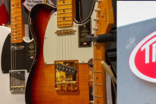 Row of colorful electric guitars on display in a music store, with a sunburst guitar in the foreground and a True Tone Music sign on the right.