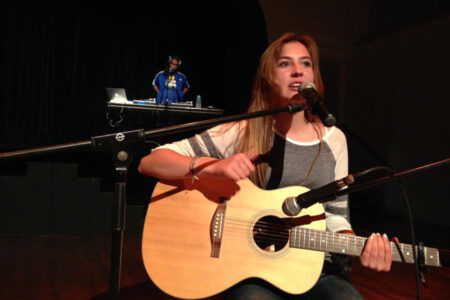 Downbeat 720 - girl playing guitar