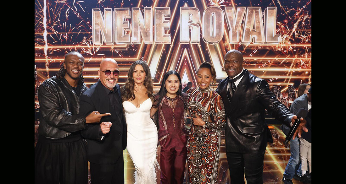 Six people pose for a group photo on a brightly lit talent show stage with a fireworks backdrop and a large 'NENE ROYAL' sign above them, suggesting judges or hosts.